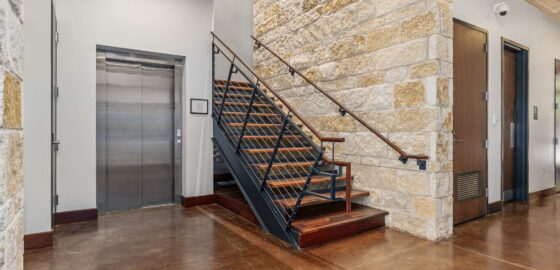 Elevator and staircase in 6150 Sherry Lane, leased by HPI.